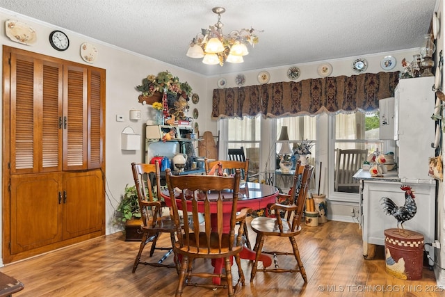 819 W Elm St, Durant, OK 74701 - dining area with a textured ceiling, a chandelier, wood finished floors, and crown molding