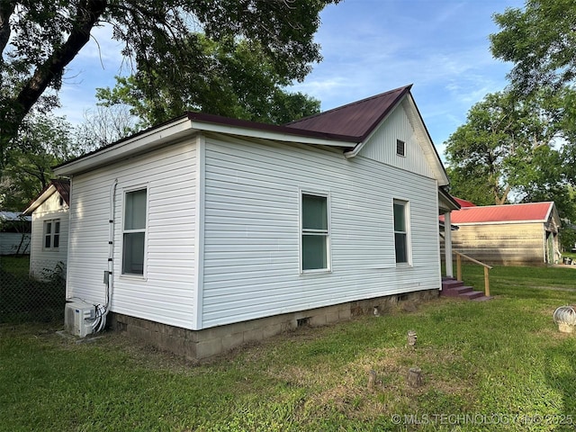 709 W Durant, Wilburton, OK 74578 - view of side of property with a lawn, metal roof, and entry steps