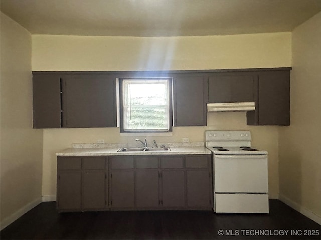 709 W Durant, Wilburton, OK 74578 - kitchen featuring electric stove, a sink, under cabinet range hood, baseboards, and light countertops