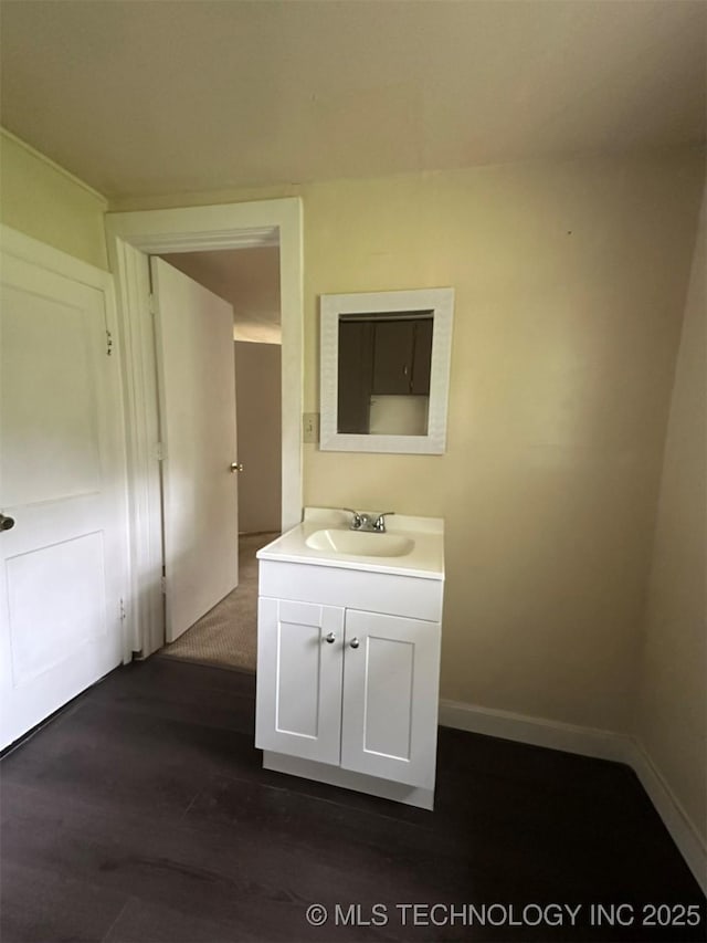 709 W Durant, Wilburton, OK 74578 - bathroom featuring wood finished floors, vanity, and baseboards
