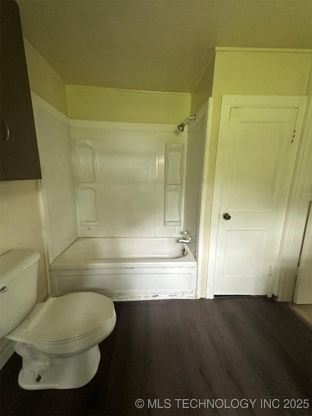 709 W Durant, Wilburton, OK 74578 - bathroom with wood finished floors, toilet, and tub / shower combination