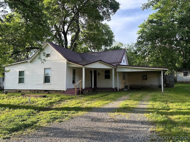 709 W Durant, Wilburton, OK 74578 - view of front facade featuring driveway, a porch, crawl space, and metal roof