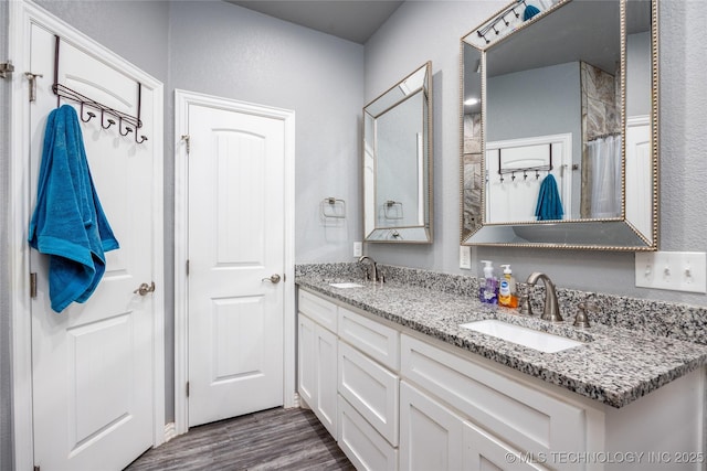 71 Rebel Ln, Durant, OK 74701 - bathroom with wood finished floors and double vanity