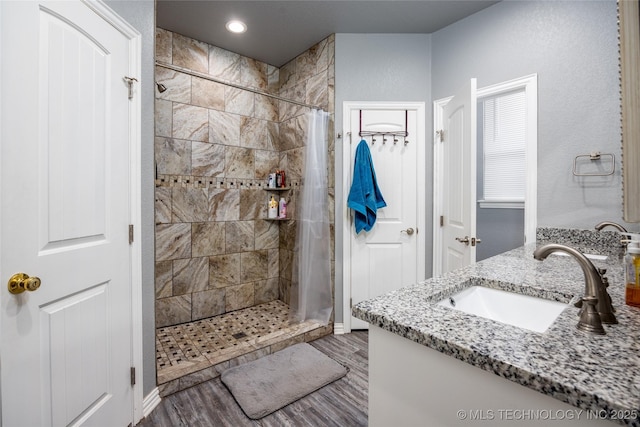 71 Rebel Ln, Durant, OK 74701 - bathroom with a tile shower, wood finished floors, vanity, and recessed lighting