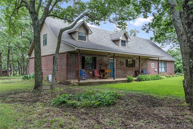 10797 S Talala Creek Ct # B, Talala, OK 74080 - cape cod-style house with brick siding, a shingled roof, and a front lawn