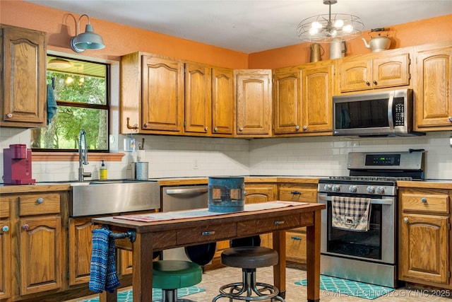 10797 S Talala Creek Ct # B, Talala, OK 74080 - kitchen with appliances with stainless steel finishes, backsplash, light countertops, and brown cabinetry