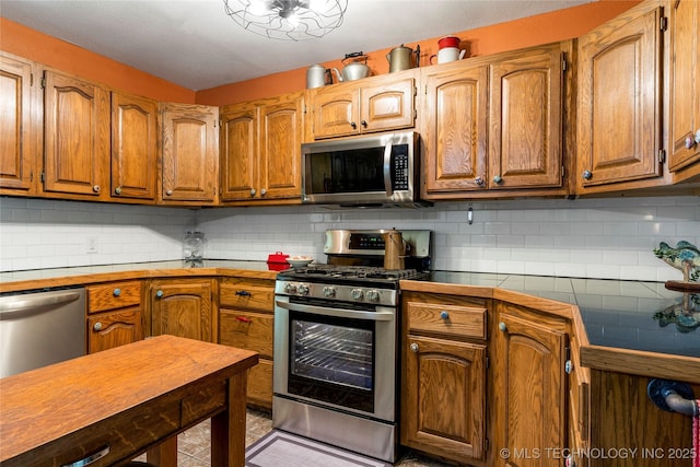 10797 S Talala Creek Ct # B, Talala, OK 74080 - kitchen with stainless steel appliances, brown cabinets, and tile counters