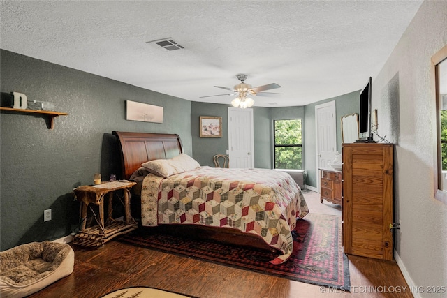 10797 S Talala Creek Ct # B, Talala, OK 74080 - bedroom with a textured wall, wood finished floors, a textured ceiling, and a ceiling fan