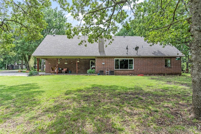 10797 S Talala Creek Ct # B, Talala, OK 74080 - rear view of property featuring a lawn, a chimney, brick siding, and a shingled roof
