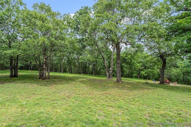 10797 S Talala Creek Ct # B, Talala, OK 74080 - view of grassy yard featuring a forest view