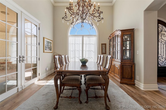 12432 Boulder Rdg, Sperry, OK 74073 - dining area with french doors, wood finished floors, a chandelier, baseboards, and crown molding