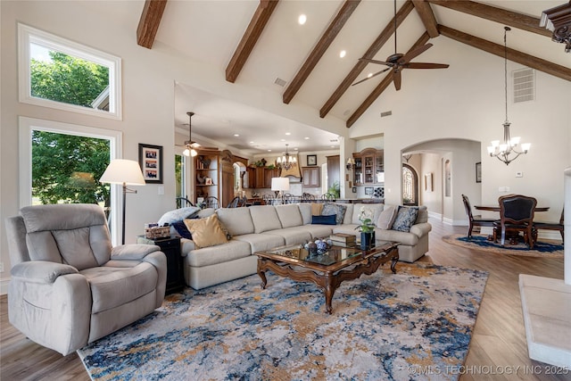 12432 Boulder Rdg, Sperry, OK 74073 - living room with a chandelier, high vaulted ceiling, ceiling fan, arched walkways, and beam ceiling