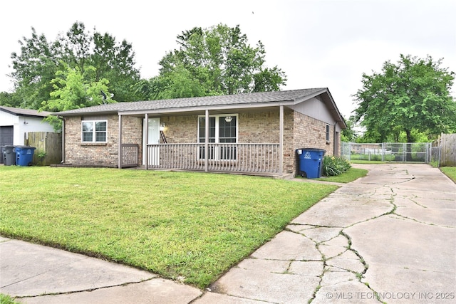 12518 E 25th St, Tulsa, OK 74129 - ranch-style house with concrete driveway, covered porch, and brick siding