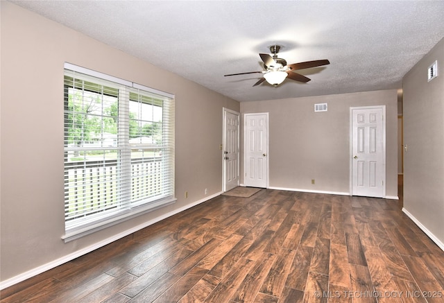 12518 E 25th St, Tulsa, OK 74129 - spare room with dark wood-type flooring, ceiling fan, baseboards, and a textured ceiling