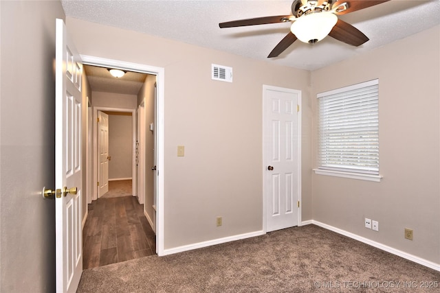 12518 E 25th St, Tulsa, OK 74129 - unfurnished bedroom with dark colored carpet, baseboards, and ceiling fan