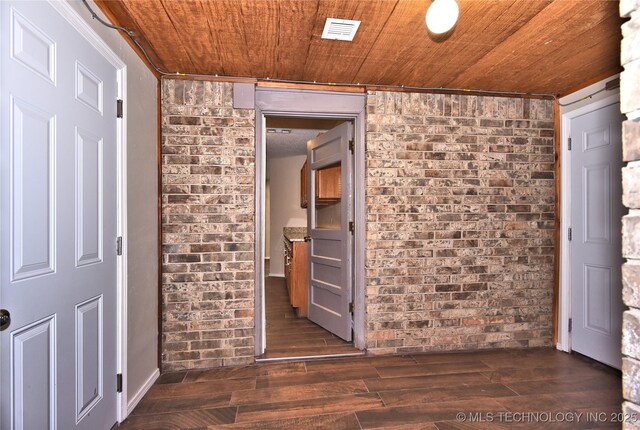 12518 E 25th St, Tulsa, OK 74129 - empty room featuring brick wall, wood ceiling, and dark wood finished floors