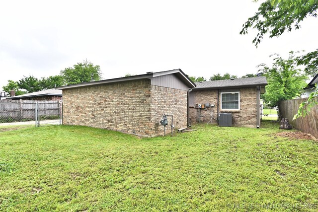 12518 E 25th St, Tulsa, OK 74129 - back of property featuring central AC and brick siding