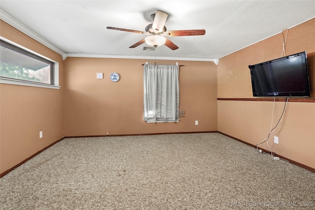 carpeted spare room featuring ceiling fan, crown molding, and baseboards