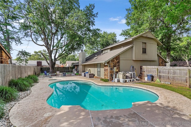 view of pool with a patio and a fenced backyard