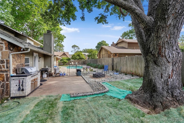 view of yard with an outdoor fire pit and a patio area