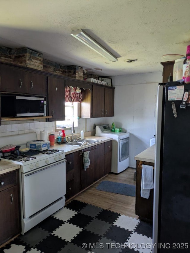 115 W Lisa Ln, Big Cabin, OK 74332 - kitchen featuring stainless steel appliances, dark brown cabinetry, light countertops, a textured ceiling, and wood finished floors
