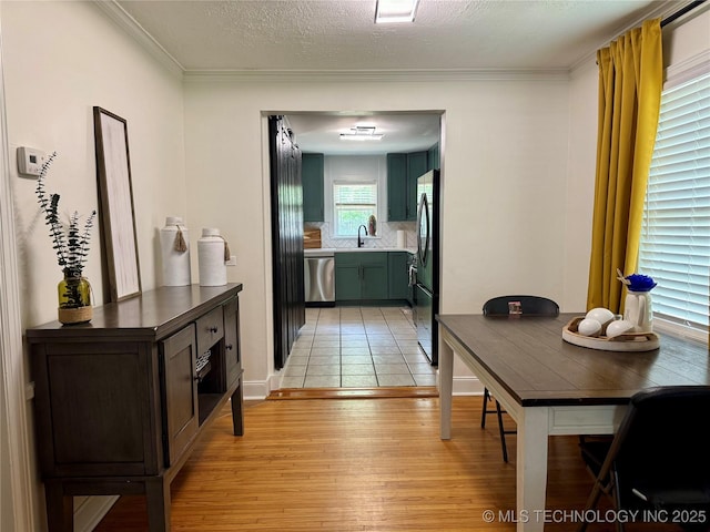 2009 S Osage Ave, Bartlesville, OK 74006 - hallway featuring a sink, light wood-style flooring, and ornamental molding