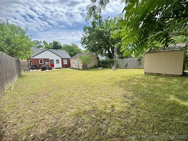 2009 S Osage Ave, Bartlesville, OK 74006 - view of yard featuring a storage unit and an outdoor structure