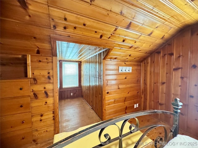 2009 S Osage Ave, Bartlesville, OK 74006 - bedroom featuring wood ceiling, wooden walls, vaulted ceiling, and wood finished floors