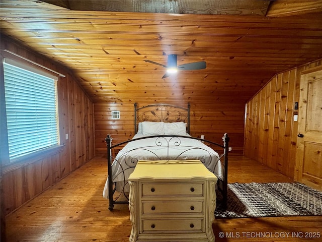 2009 S Osage Ave, Bartlesville, OK 74006 - bedroom featuring lofted ceiling, wood walls, light wood-style floors, and wooden ceiling