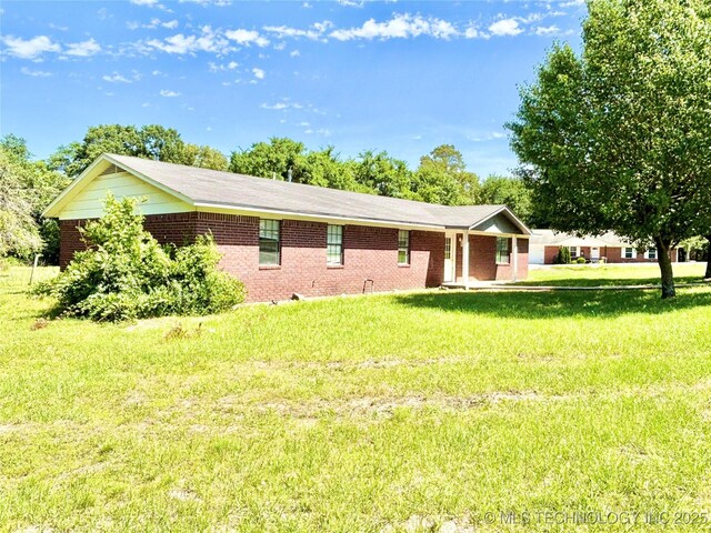 404 David Walker Ln, Stigler, OK 74462 - view of side of home featuring a lawn and brick siding