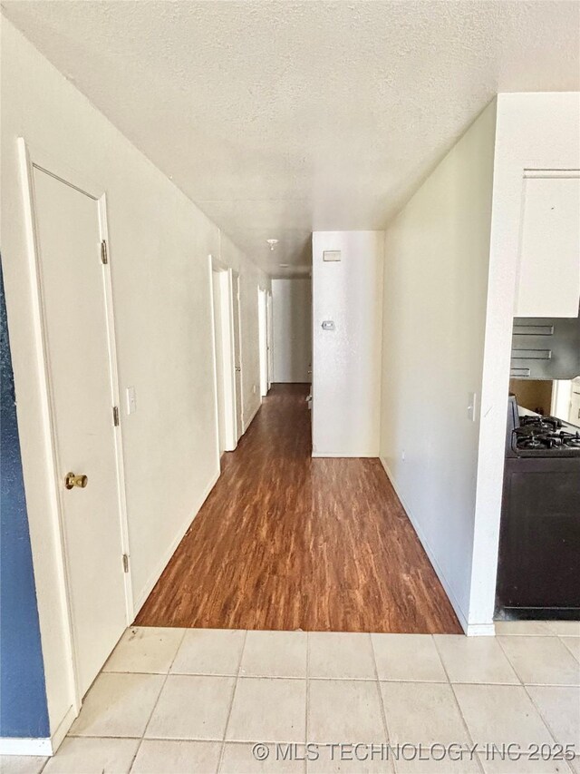 404 David Walker Ln, Stigler, OK 74462 - hall with wood finished floors and a textured ceiling