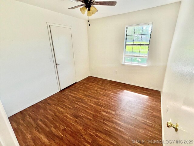 404 David Walker Ln, Stigler, OK 74462 - spare room featuring a ceiling fan, wood finished floors, and baseboards
