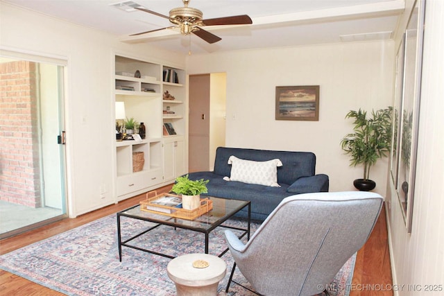 4507 S Irvington Ave, Tulsa, OK 74135 - living room featuring wood finished floors, ceiling fan, and built in features