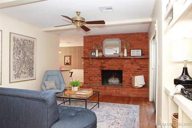 4507 S Irvington Ave, Tulsa, OK 74135 - living area featuring wood finished floors, a ceiling fan, and a brick fireplace