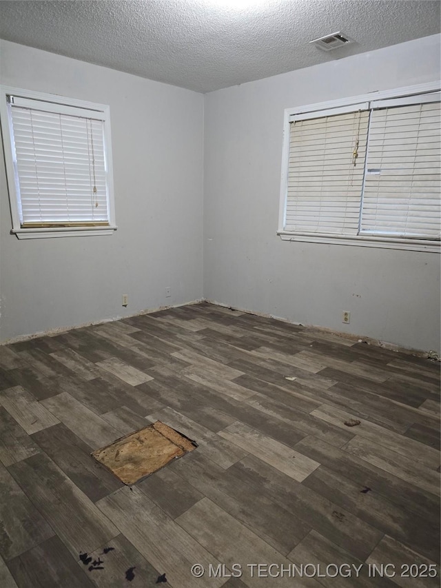 309 Hillcrest St, Pawnee, OK 74058 - empty room with wood finished floors and a textured ceiling