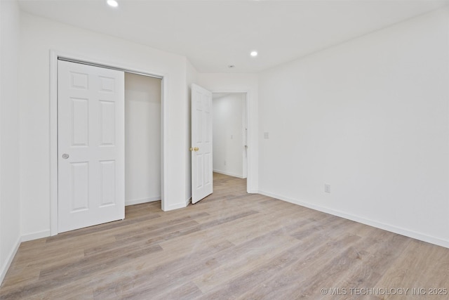 3919 E Archer St, Tulsa, OK 74115 - unfurnished bedroom featuring wood finished floors, recessed lighting, and a closet