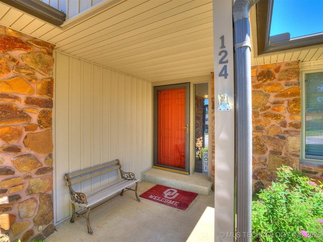 124 Canterbury Ct, Bartlesville, OK 74006 - doorway to property featuring stone siding