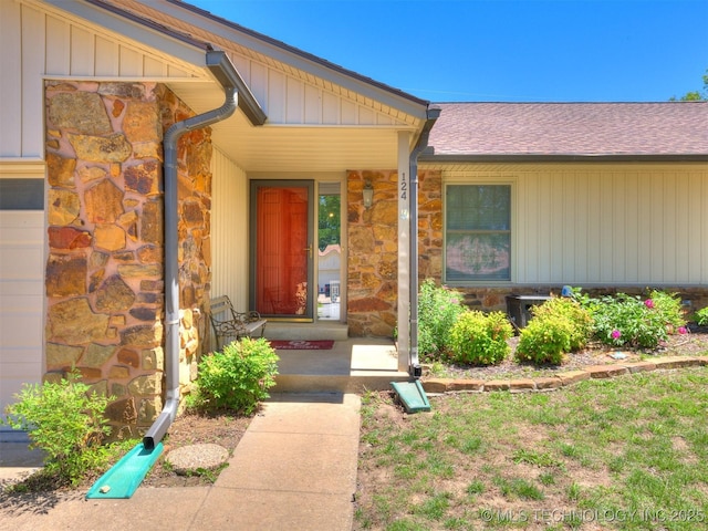 124 Canterbury Ct, Bartlesville, OK 74006 - property entrance featuring stone siding and roof with shingles