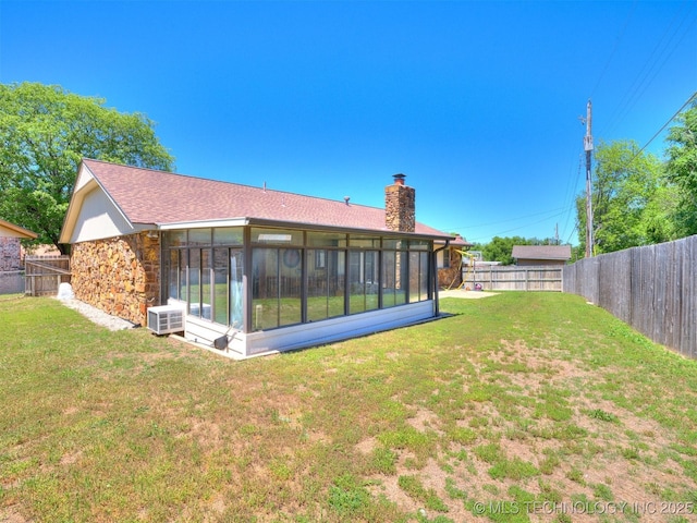 124 Canterbury Ct, Bartlesville, OK 74006 - back of house with a chimney, a sunroom, stone siding, and a shingled roof