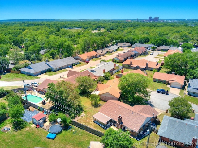 124 Canterbury Ct, Bartlesville, OK 74006 - aerial view of residential area featuring a heavily wooded area