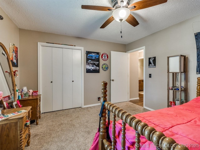 124 Canterbury Ct, Bartlesville, OK 74006 - carpeted bedroom with a textured ceiling, a closet, ceiling fan, and baseboards