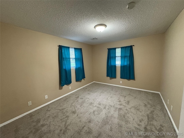 823 Sooner Park Dr, Bartlesville, OK 74006 - spare room featuring carpet flooring, a textured ceiling, and baseboards