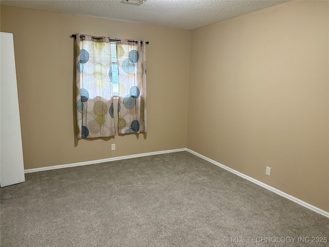 823 Sooner Park Dr, Bartlesville, OK 74006 - empty room featuring carpet flooring, a textured ceiling, and baseboards