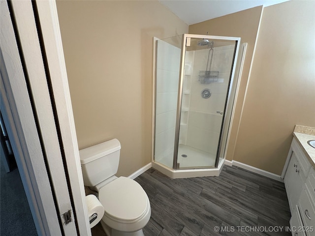 823 Sooner Park Dr, Bartlesville, OK 74006 - bathroom with baseboards, a shower stall, wood finished floors, and toilet