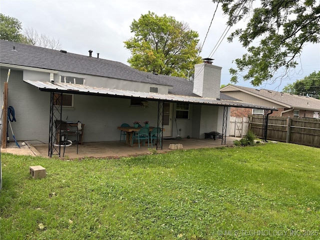 823 Sooner Park Dr, Bartlesville, OK 74006 - back of house with a patio, a chimney, brick siding, and roof with shingles