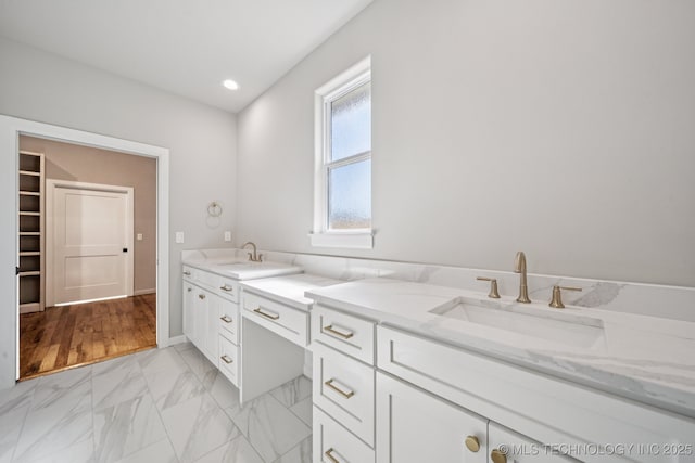 682 W 113th Ct S, Jenks, OK 74037 - bathroom featuring marble look tile flooring, double vanity, recessed lighting, and a walk in closet