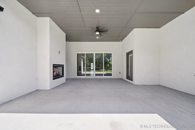 682 W 113th Ct S, Jenks, OK 74037 - view of patio / terrace featuring a warm lit fireplace and ceiling fan