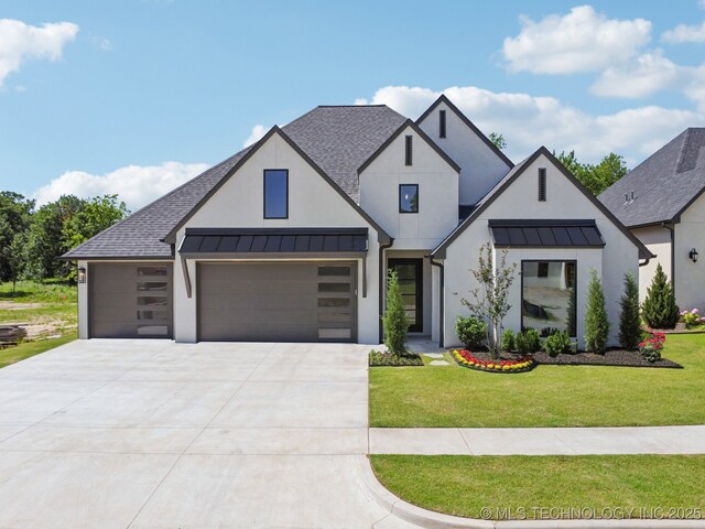 682 W 113th Ct S, Jenks, OK 74037 - view of front of house with a standing seam roof, stucco siding, driveway, a garage, and a front lawn