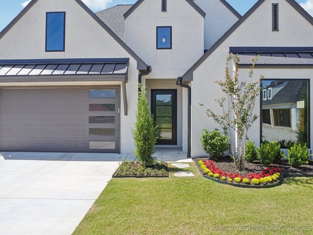 682 W 113th Ct S, Jenks, OK 74037 - view of front facade with a standing seam roof, concrete driveway, stucco siding, and a garage