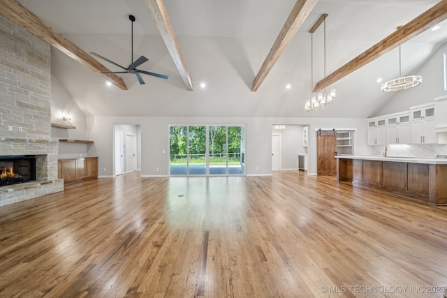 682 W 113th Ct S, Jenks, OK 74037 - unfurnished living room featuring high vaulted ceiling, a stone fireplace, a ceiling fan, beam ceiling, and light wood-type flooring
